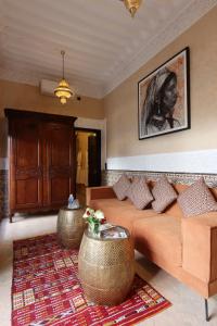 a living room with a couch and a table at Riad Atlas Dama in Marrakech