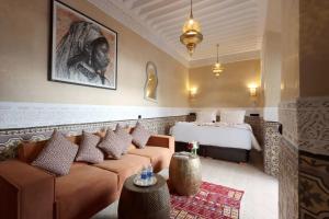 a hotel room with a couch and a bed at Riad Atlas Dama in Marrakech