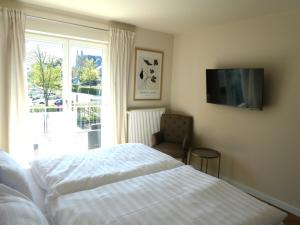a bedroom with a bed and a tv on the wall at Fewo Anna in Bernkastel-Kues