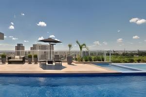 a swimming pool with a view of a building at Studio Duo Jk Requinte 904 in Sao Jose do Rio Preto