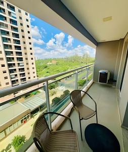a balcony with chairs and a view of a building at Studio Duo Jk Requinte 904 in Sao Jose do Rio Preto