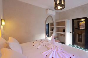 a bedroom with a bed with a mirror on it at Riad Atlas Dama in Marrakech