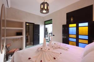 a bedroom with a white bed with two pillows at Riad Atlas Dama in Marrakech