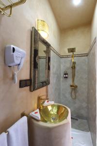 a bathroom with a sink and a mirror at Riad Atlas Dama in Marrakech