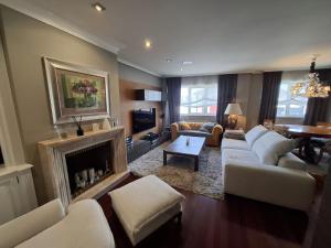 a living room with a couch and a fireplace at Duplex A Mosquera by Foroplaza Pleno centro Vistas muralla in Lugo