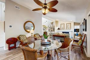 a dining room and living room with a ceiling fan at Surfscoter 94 in Kiawah Island +23 photos