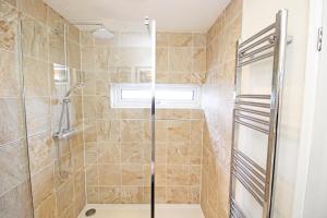 a bathroom with a shower with a glass door at Dros Y Dwr in Porthmadog +20 photos