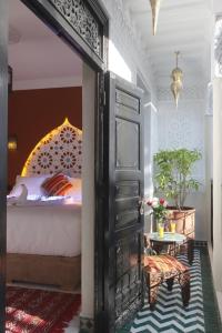 a bedroom with a bed and an open door at Riad Atlas Dama in Marrakech