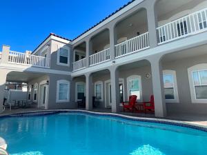 a swimming pool in front of a house at FamReunion,EVcharger,3LotsToBeach,HeatedPool,Jacuzzi in South Padre Island