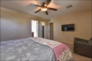 a bedroom with a ceiling fan and a bed at El Paso Comfy Home in El Paso