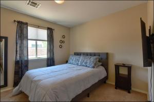a bedroom with a bed and a window at El Paso Comfy Home in El Paso