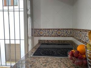 a kitchen with a stove and a bowl of fruit at El Rincón del Tuno in Carmona +16 photos