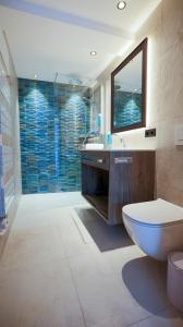 a bathroom with a toilet and a sink and a mirror at NordOst fineliving in Ischgl +42 photos
