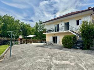 a house with a patio and a table and benches at Maison Miranda nord Portugal in Represas