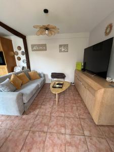 a living room with a couch and a table at Bessi - Maison de charme Trouville sur mer in Trouville-sur-Mer