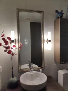 a bathroom with a white sink and a mirror at Luukkaan Helmi in Lappeenranta