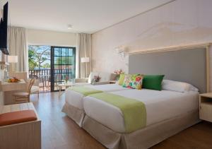 a large bedroom with a large bed in a room at Hotel Jardín Tecina in Playa de Santiago