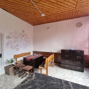 a room with a desk and a table and chairs at Backpackers House Near The Church in Samarkand +25 photos
