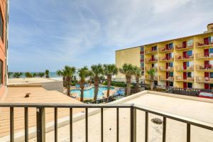 a view of a hotel with a pool and palm trees at Steps to Sand Myrtle Beach Gem with Oceanfront Pool in Myrtle Beach