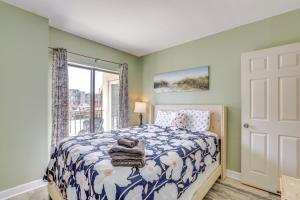 a bedroom with a bed and a window at Steps to Sand Myrtle Beach Gem with Oceanfront Pool in Myrtle Beach +22 photos