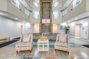 a lobby with two chairs and a table at Steps to Sand Myrtle Beach Gem with Oceanfront Pool in Myrtle Beach