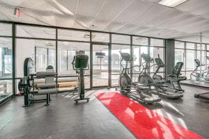 a gym with treadmills and ellipticals in a building at Steps to Sand Myrtle Beach Gem with Oceanfront Pool in Myrtle Beach