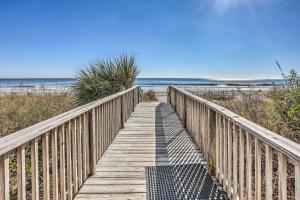a wooden boardwalk leading to the beach at Steps to Sand Myrtle Beach Gem with Oceanfront Pool in Myrtle Beach