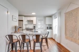 a kitchen with a island with four chairs around it at Walkable Dtwn Townhome Near Campus and Palmer Square in Princeton