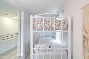 a white crib in a room with white walls at Walk to Campus and Palmer Square Dtwn Townhome in Princeton