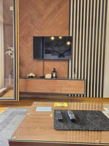 a living room with a flat screen tv on a wall at Apartman Žaxtef Wellnes&Spa in Zlatibor