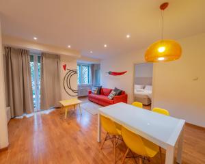 a living room with a white table and yellow chairs at San Paolo Apartment in Pisa