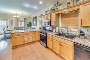 a kitchen with wooden cabinets and a stove top oven at 2 Mi to Branson Landing Quiet Home with Lake View in Branson