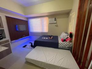 a bedroom with two beds with stuffed animals on it at Cozy City Escape - Avida Aspira Tower 1, CDO in Cagayan de Oro +16 photos