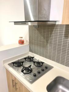 a kitchen with a stove top oven in a kitchen at Verona Home 2-Habitaciones in Montería +11 photos