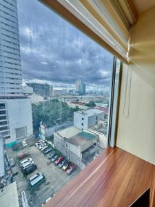 a view of a city from a window in a building at Metro Luxe Stay Near DOJ Embassy and St Lukes in Manila +13 photos