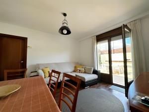 a living room with a table and a couch at Villa de Pedrena - 32801 in Pedreña