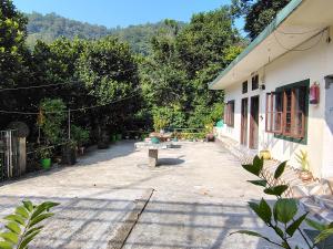 a patio of a house with a bench next to it at vishranti homestayy in Rishīkesh