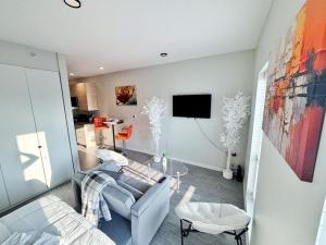 a living room with a couch and a tv at Zesty Orange Abode (438) in Des Moines