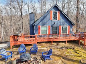 a blue and orange house with chairs in front of it at Rynns Retreat in Franklin
