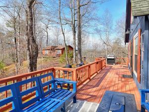 a porch with blue benches on a wooden deck at Rynns Retreat in Franklin +14 photos