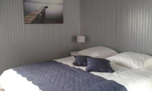 a bed with two pillows on it in a bedroom at Chambres d'Hôtes Entre Deux Rives in Honfleur