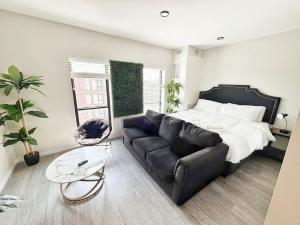 a living room with a couch and a bed at Urban Jungle Retreat (417) in Des Moines
