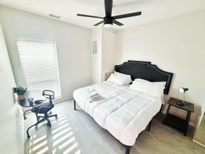 a bedroom with a large bed and a ceiling fan at The Luxe Black Haven (340) in Des Moines