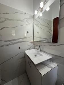 un baño con lavabo y espejo en EK-Center Vila Berat, en Berat