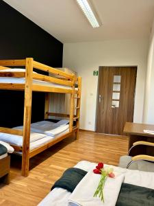 a room with two bunk beds and a table at Pokoje Astra - Energylandia in Spytkowice