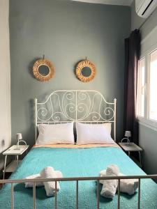 a bedroom with a bed with two mirrors on the wall at Bizaniou Central Apt - Heraklion Crete in Bendevís