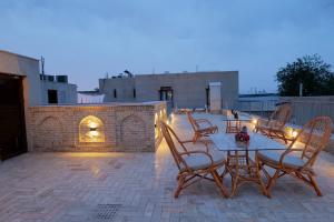 a patio with a table and chairs on a patio at Istat Boutique Hotel in Bukhara