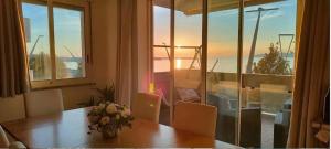 a table with chairs and a vase of flowers on it at Seahorse B&B in Alghero