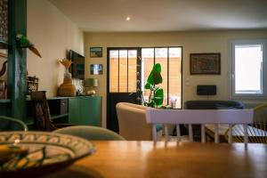 un soggiorno con tavolo e sala da pranzo di La Maison Raspail - Calme Disney RER A a Neuilly-Plaisance