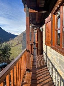 a porch of a house with wooden doors and windows at GESSA, VAL d'ARAN in Gessa
